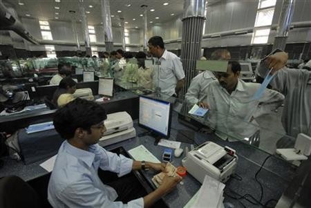 imgcashier l counts currency notes customers wait inside bank hyderabad march 22 2010