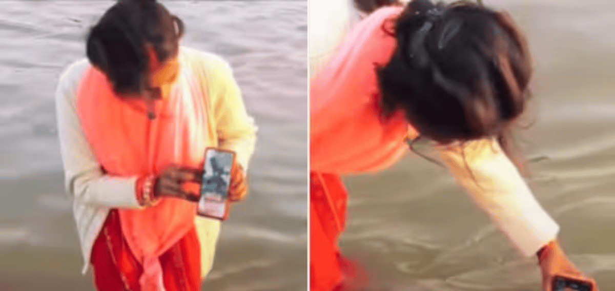 Woman Dips Mobile In Sangam