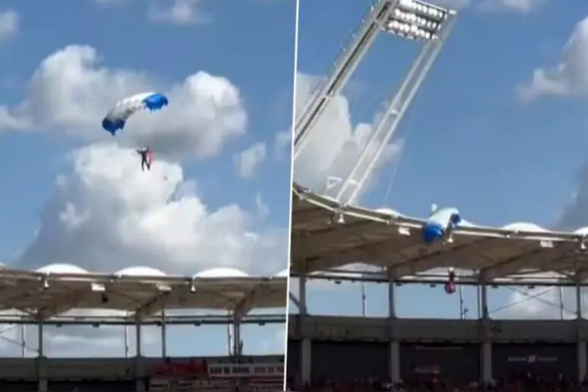 Parachutist stuck on stadium roof video