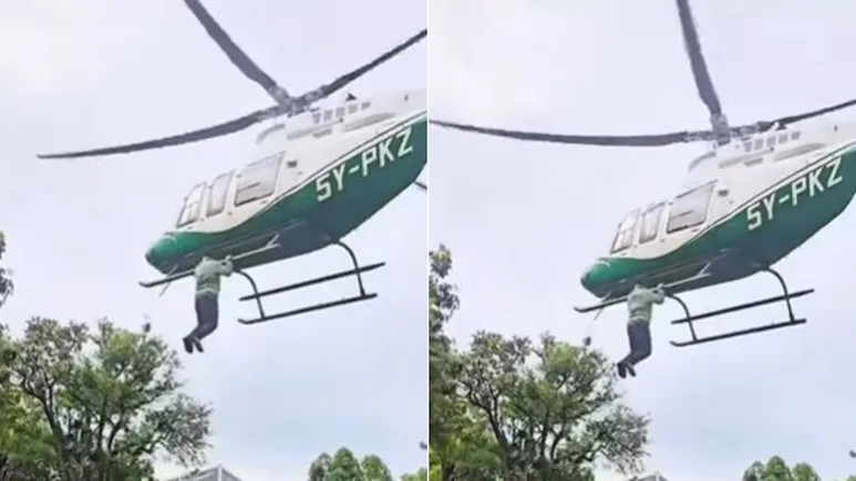 Man hang on helicopter video